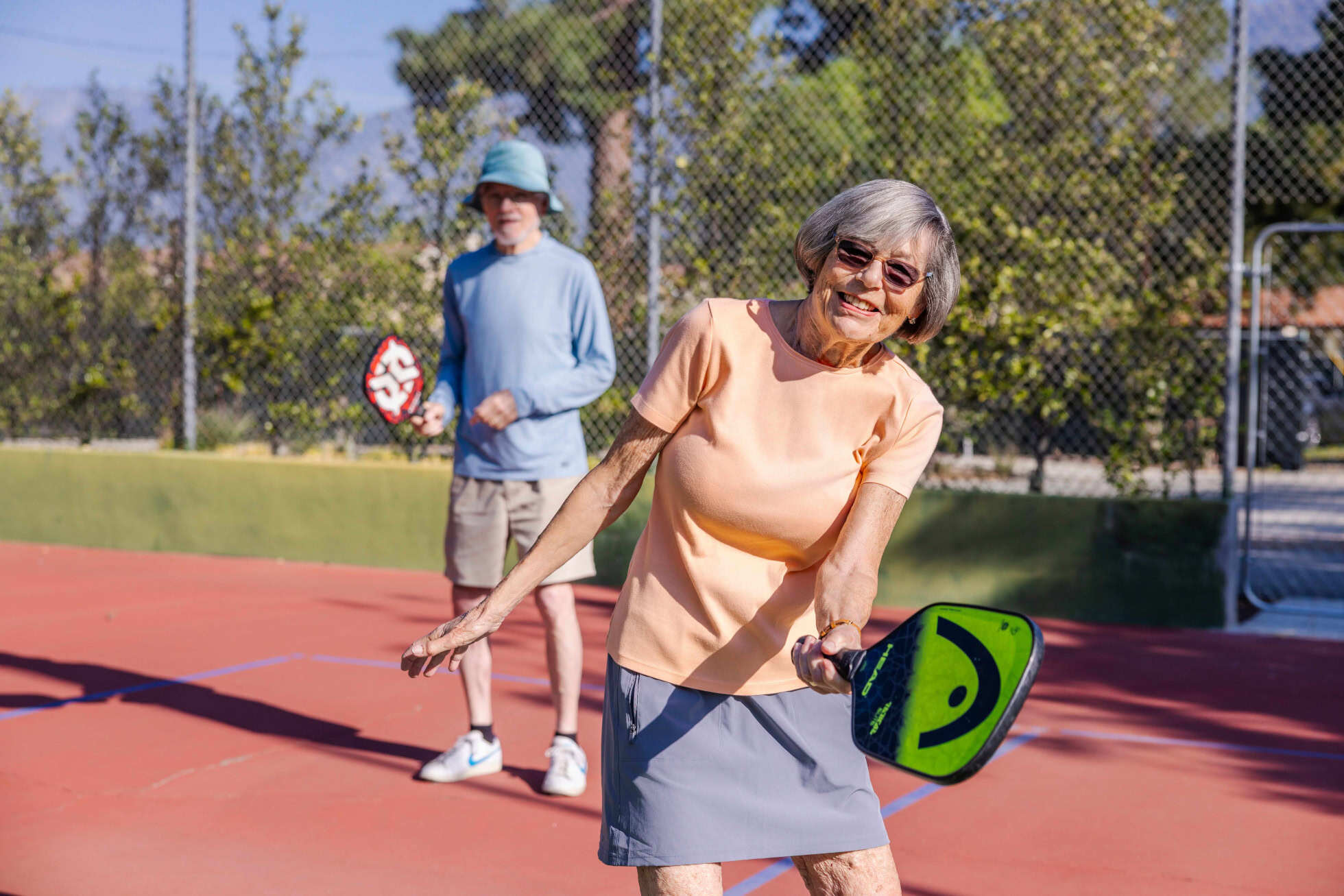 A woman and a man playing pickleball