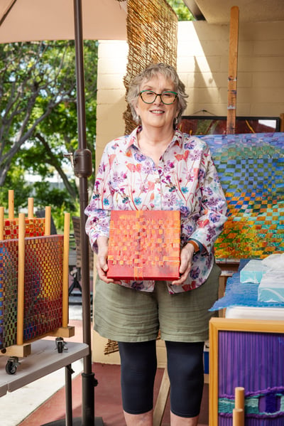 Isabel holding one of her paintings