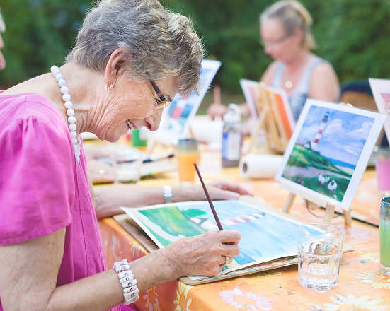 Group of women painting outdoors