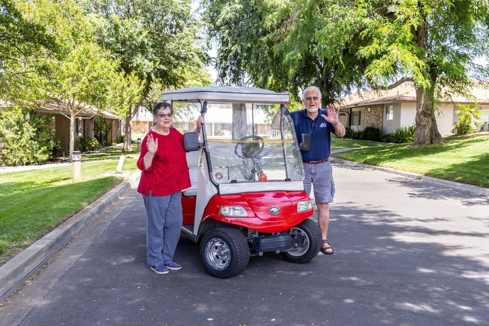 Couple with red golf cart