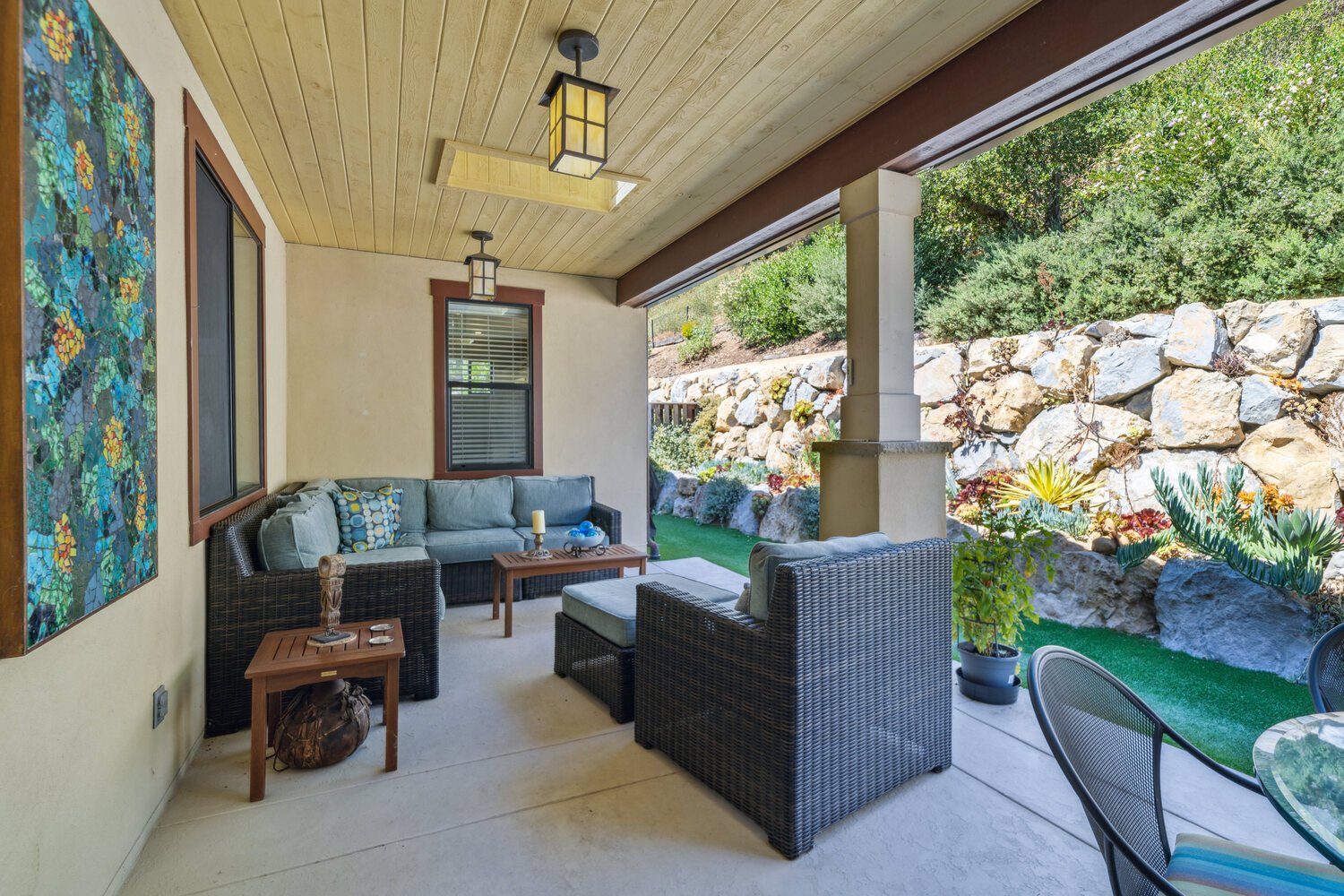 Patio with couches and small side yard