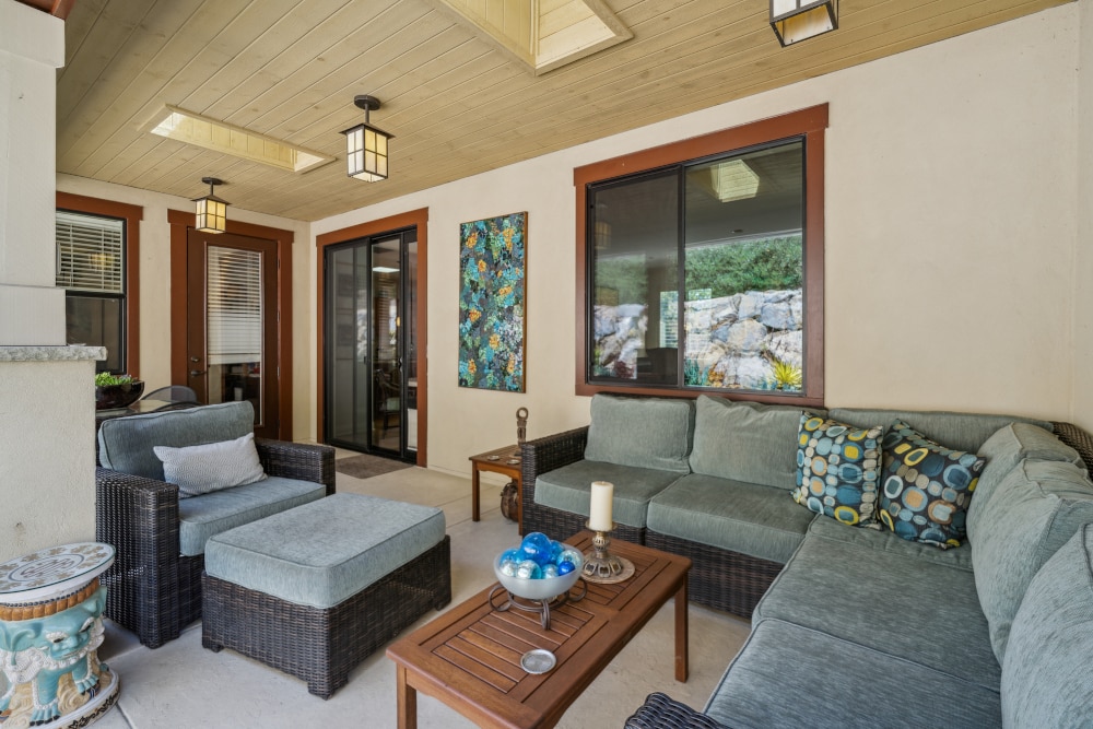 Patio seating area with L-shaped couch and coffee table