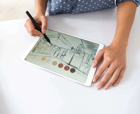 Image of a person drawing on iPad sketch software.