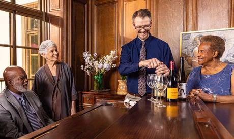 Residents drinking wine at The Mansion at Rosemont