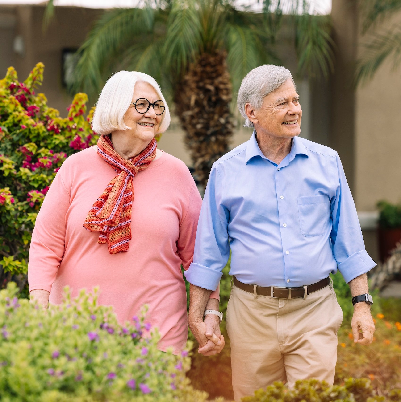 Senior couple holding hands outside in garden