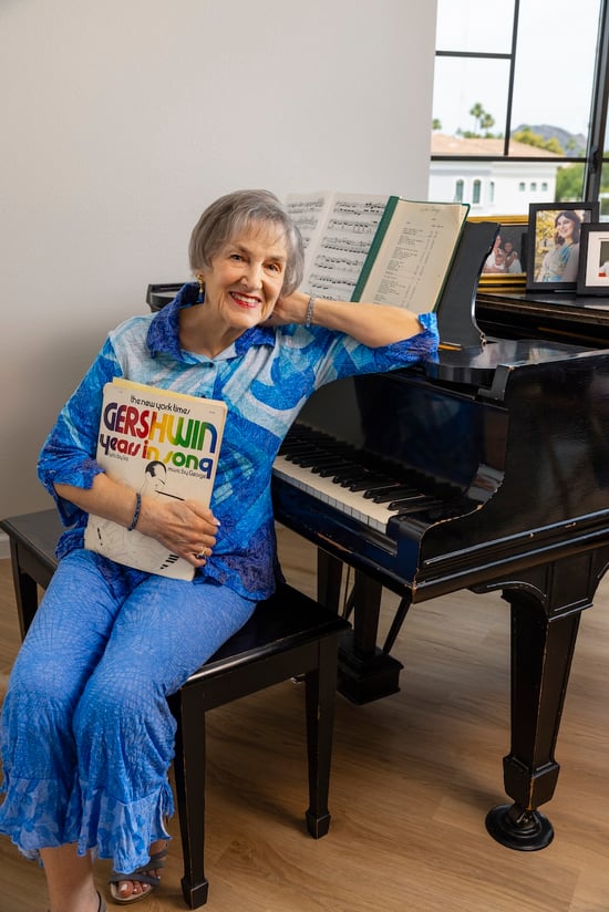 A woman sitting on a grand piano