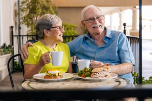 Couple eating lunch at outdoor bistro table