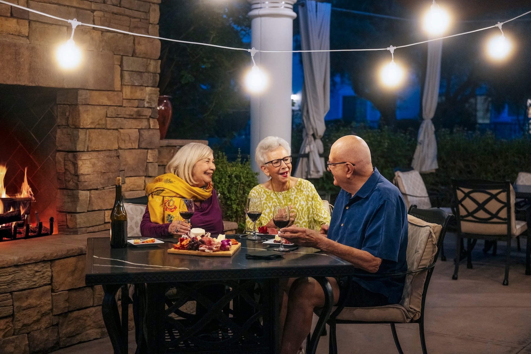 group of friends enjoying a meal by the fireplace