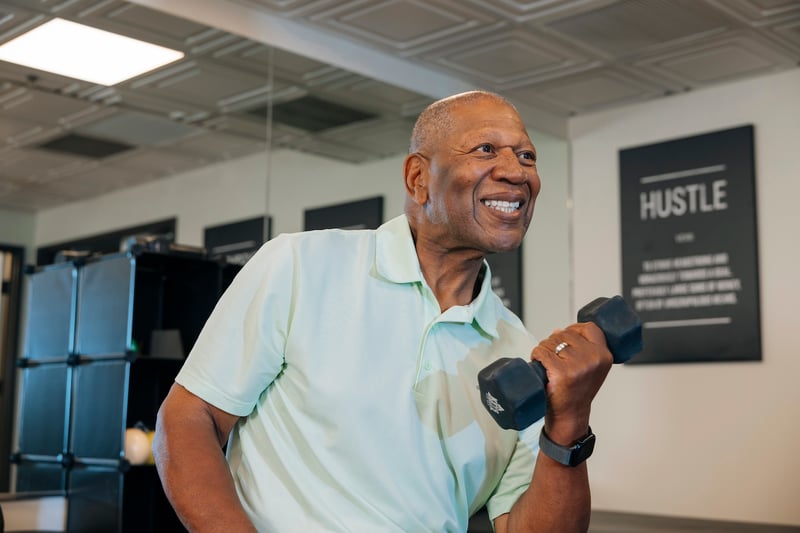 Man exercising in gym with weight