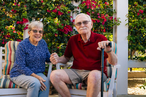 couple sits ouside under pergola
