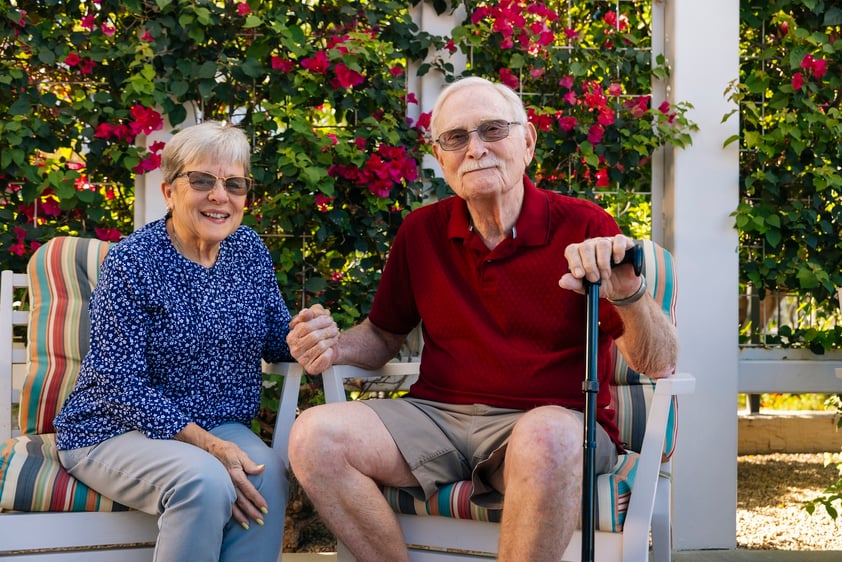 couple sits ouside under pergola