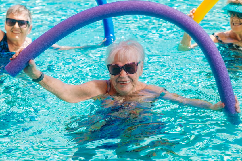 Woman with pool noodle
