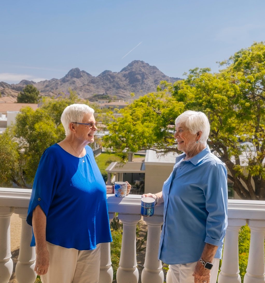 two residents on balcony outside