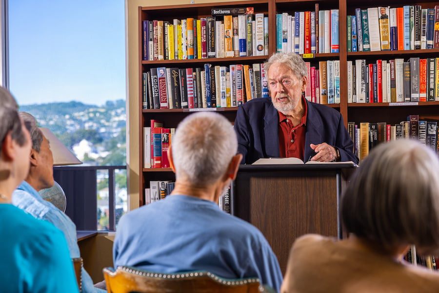 man speaking to group at library