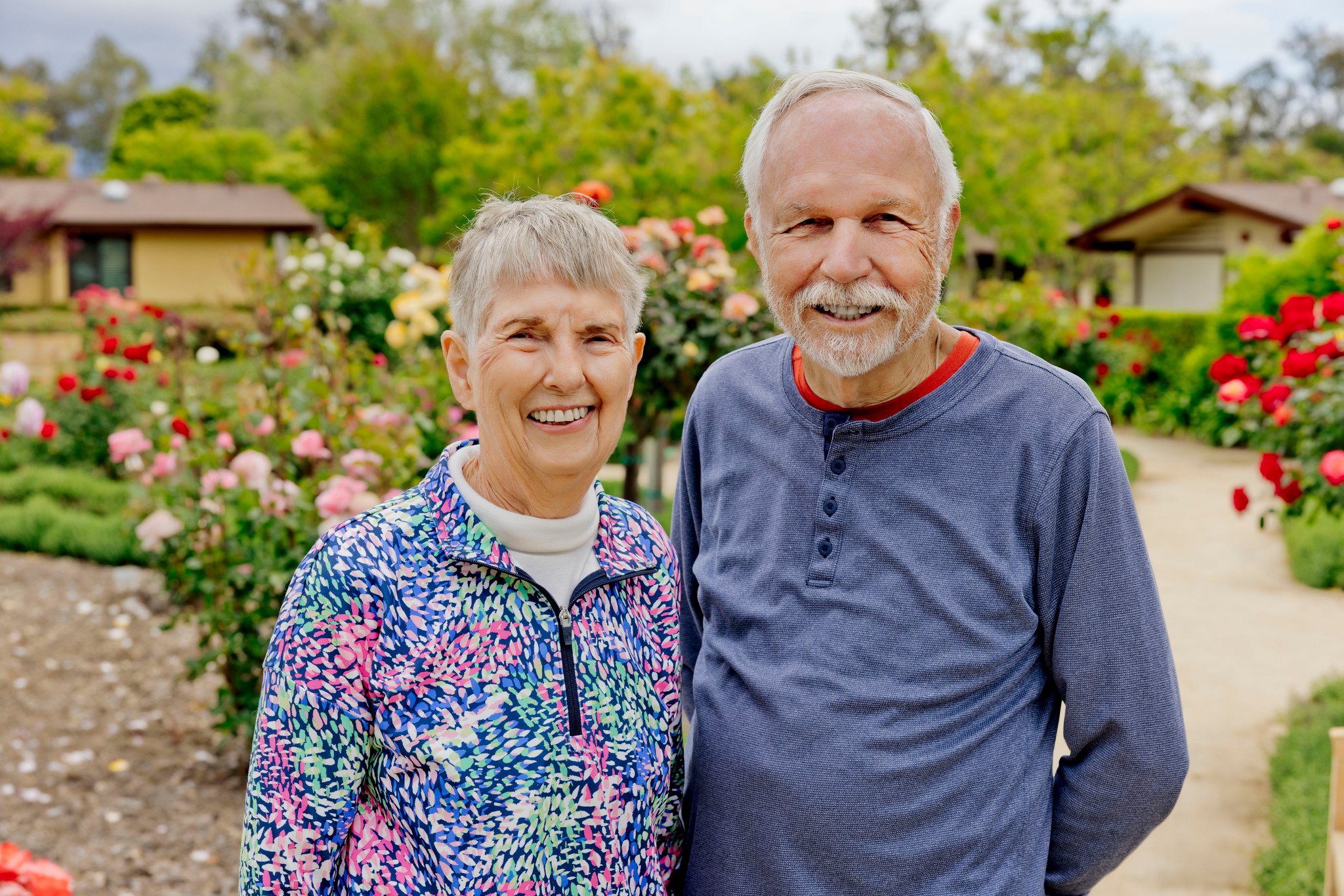 couple standing by rose garden