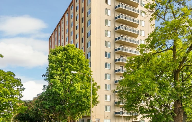 A tall building with balconies on one side