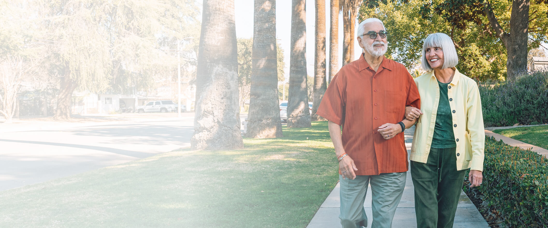 Senior man and woman walking down a sidewalk
