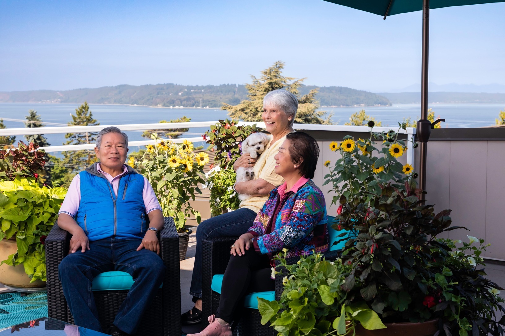 Residents relaxing on an outdoor terrace at Judson Park, a HumanGood community.