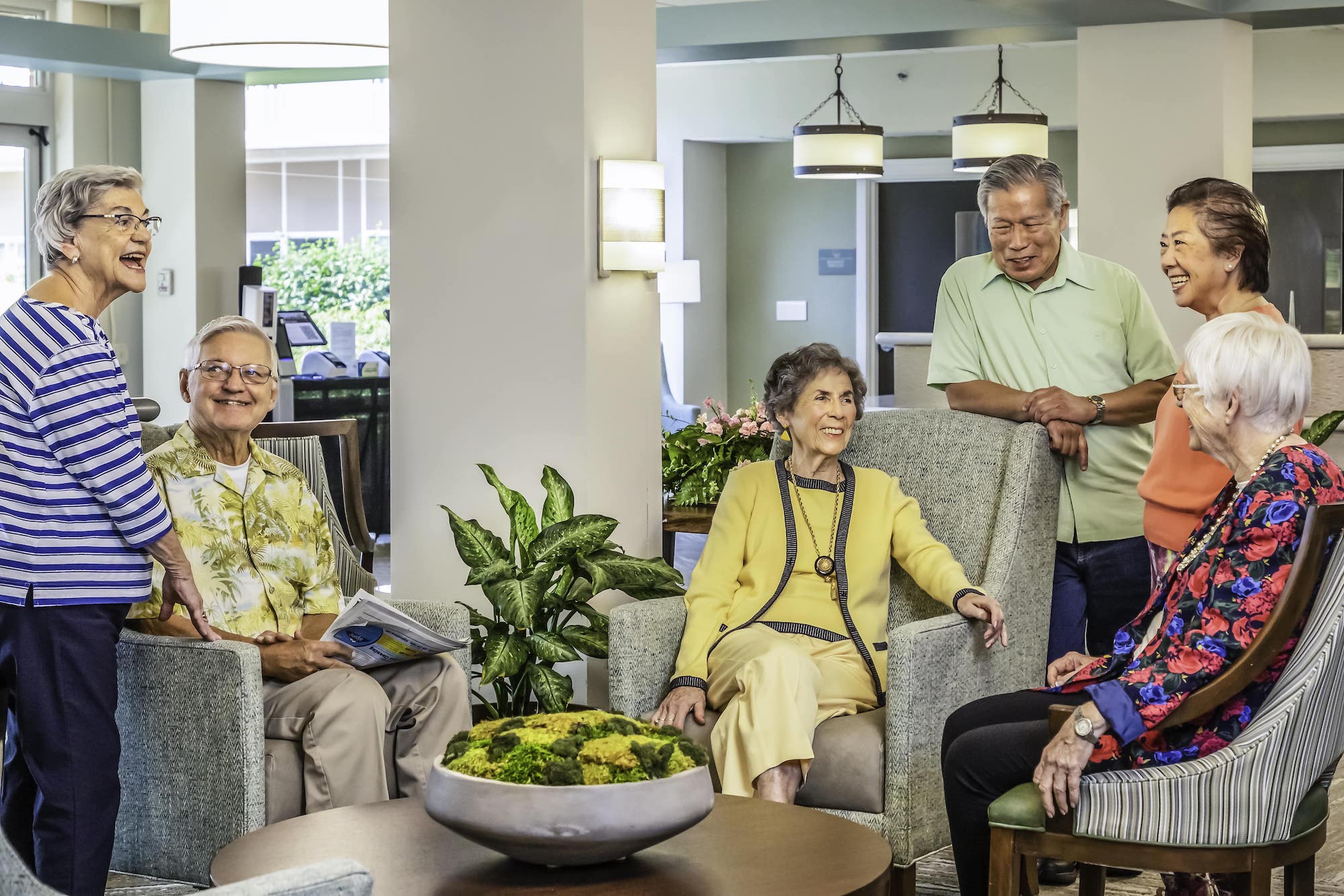 senior friends gathered in the lobby common area