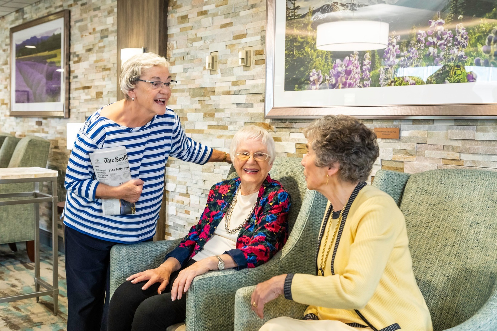 Residents socializing in a shared lounge at Judson Park, a HumanGood community.