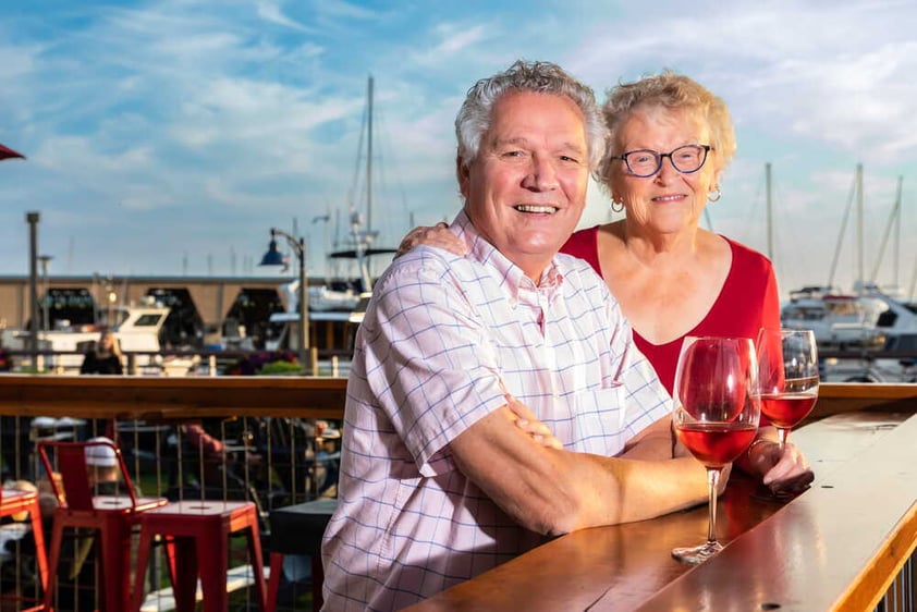 Couple having wine at marina bar