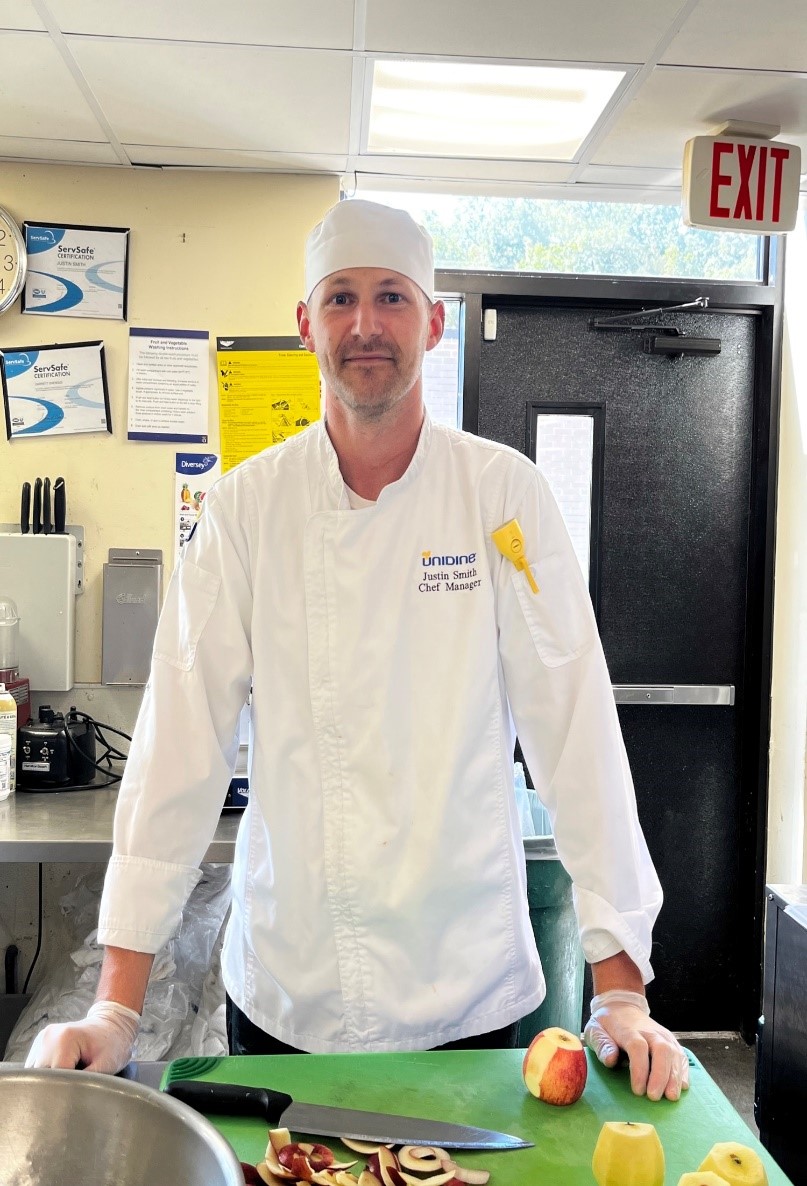 Chef Justin Smith stands in the kitchen