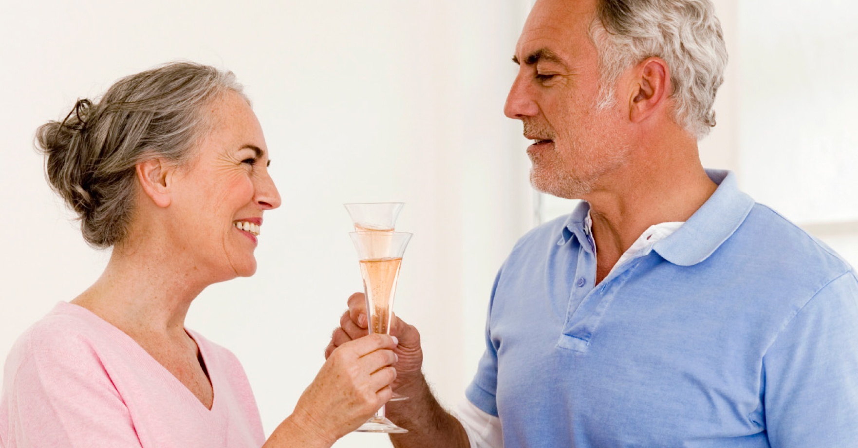senior couple clinking champagne glasses