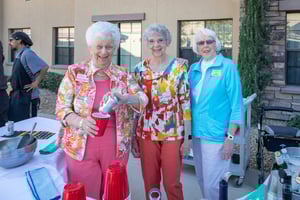 Three senior women at an outdoor community event