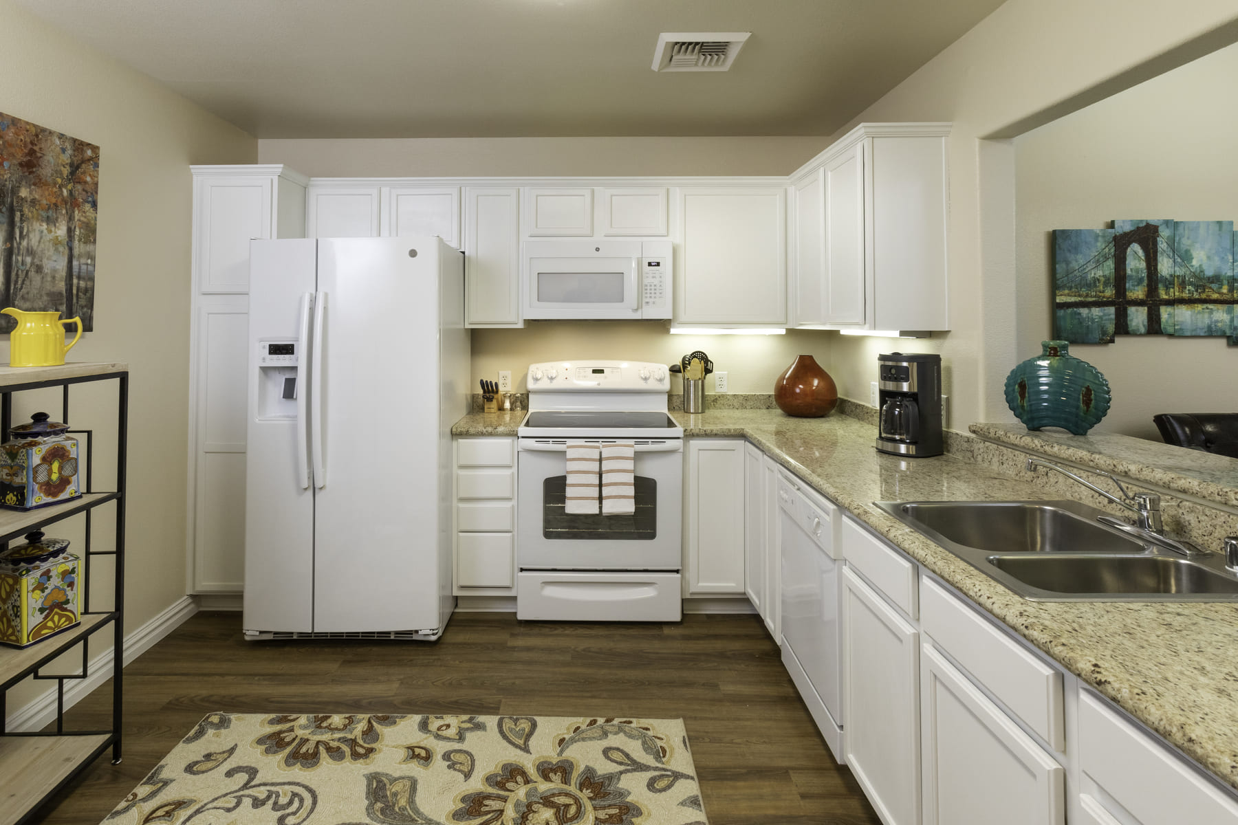 Kitchen with white cabinets and appliances of an apartment at Las Ventanas