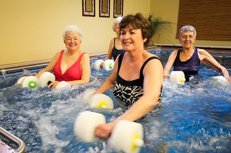 Four women exercising in a pool