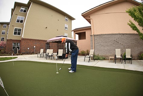 Man putting on a golf green