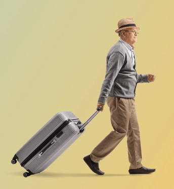 A man walking while pulling a rolling suitcase against a soft gradient background.