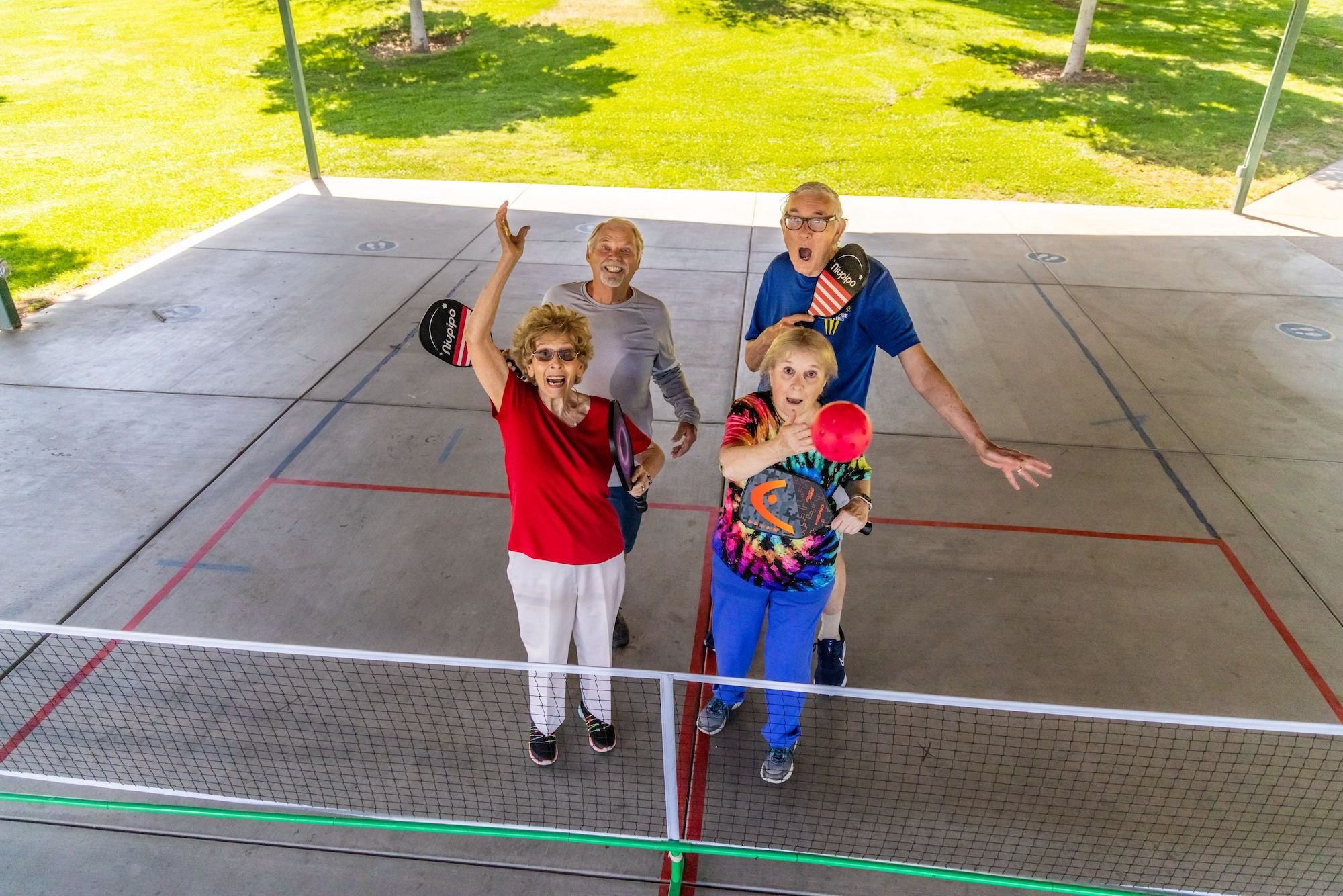 Four people on a pickleball court