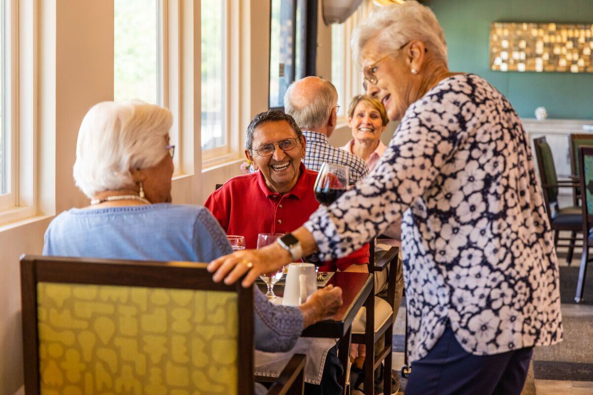Three people laughing in dining room