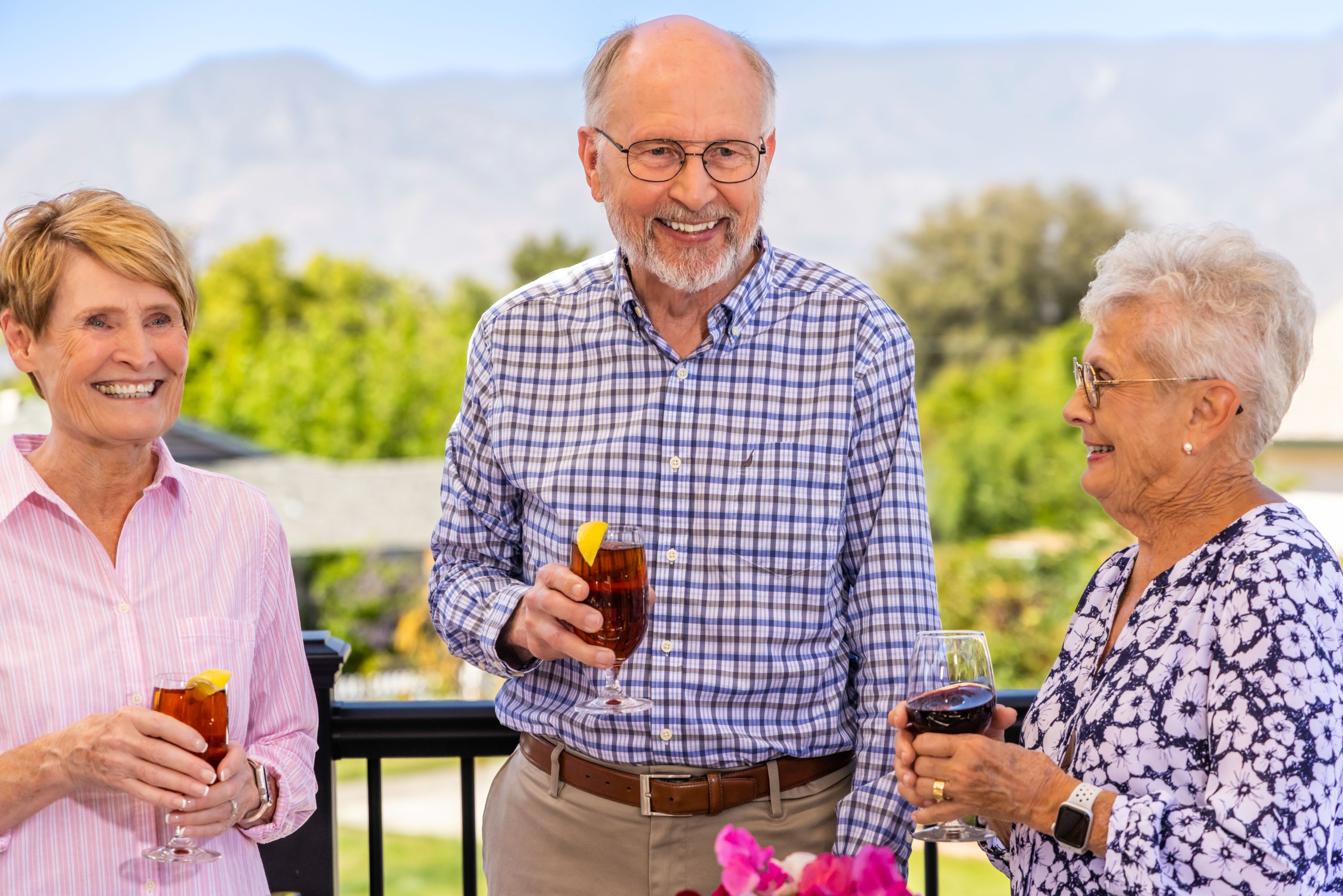 Three people on outdoor dining deck