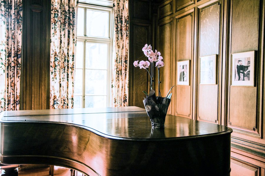 Piano in the living area of The Mansion at Rosemont