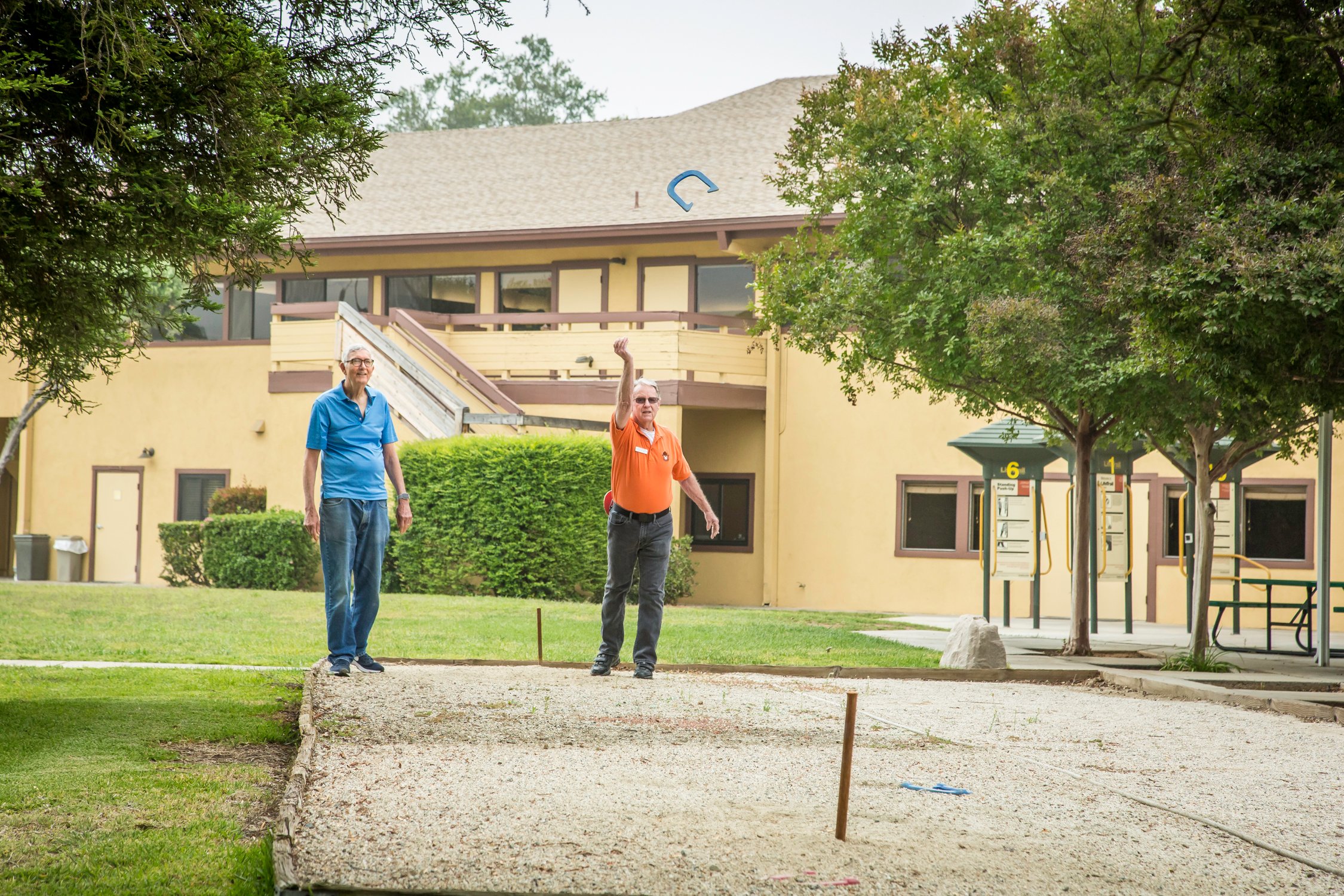 Two men playing horseshoes