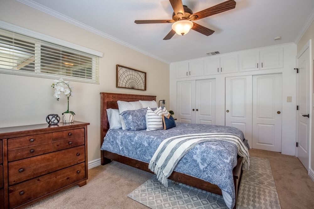 Bedroom with dresser and closets