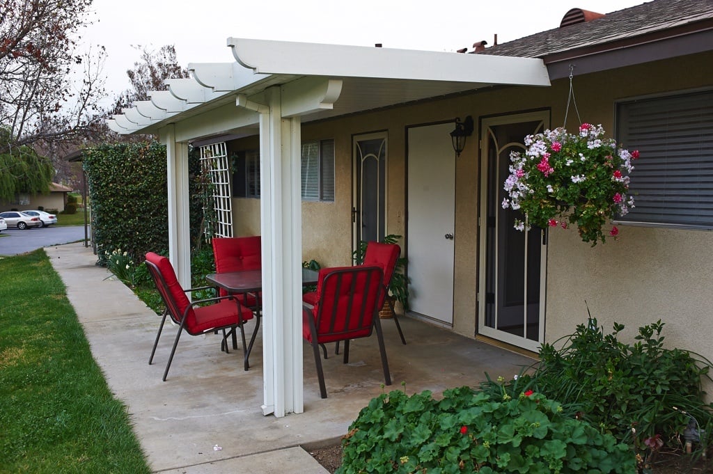 Back porch area with a table and chairs
