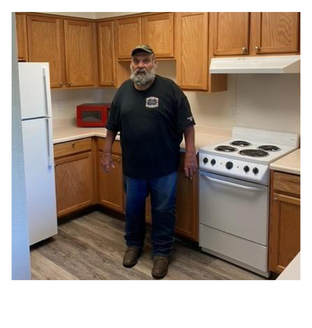 A man standing in a kitchen.