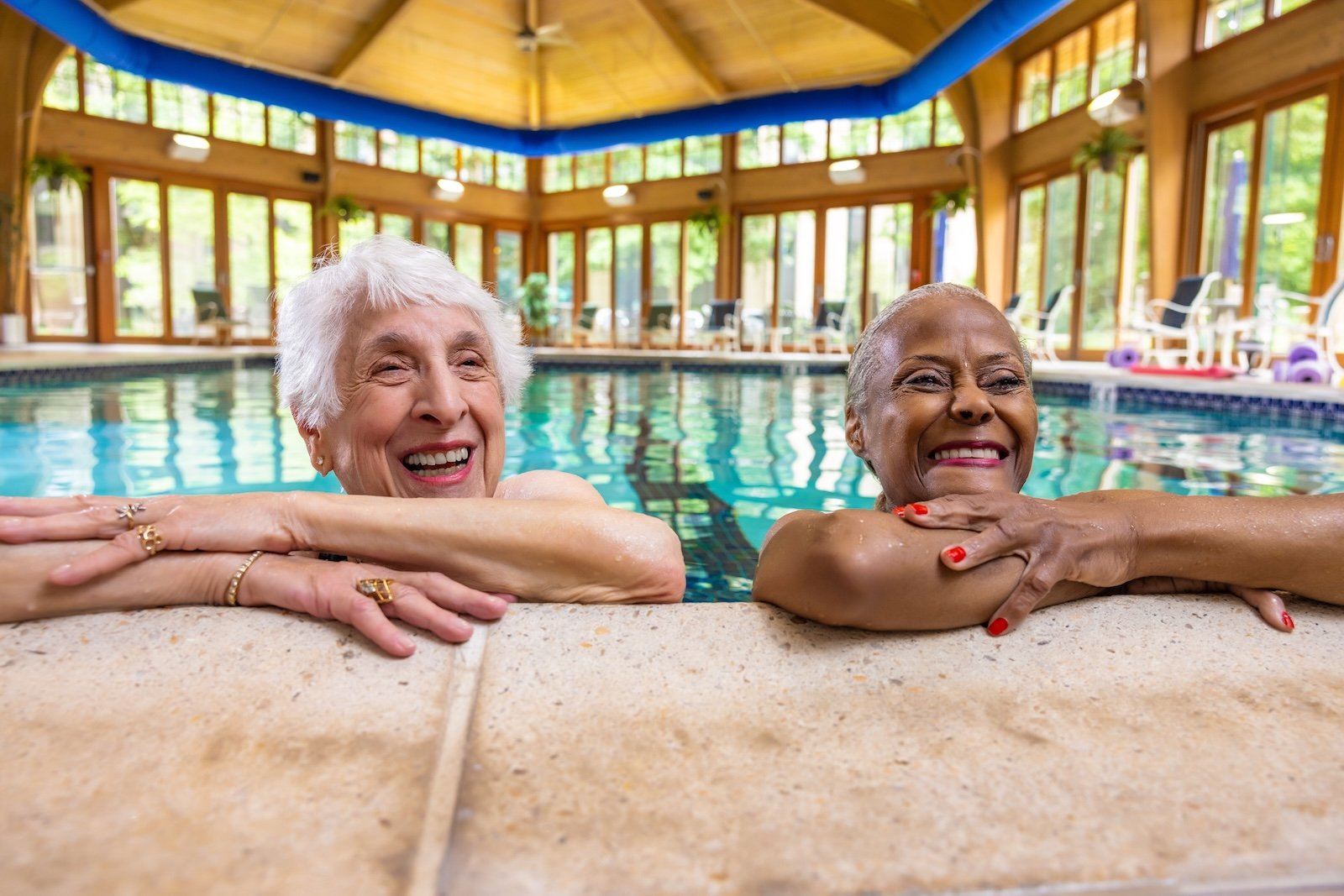 two women smiling in pool 