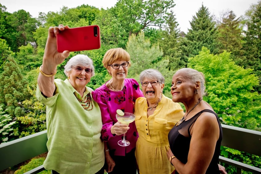 Group of four senior women taking a selfie outside