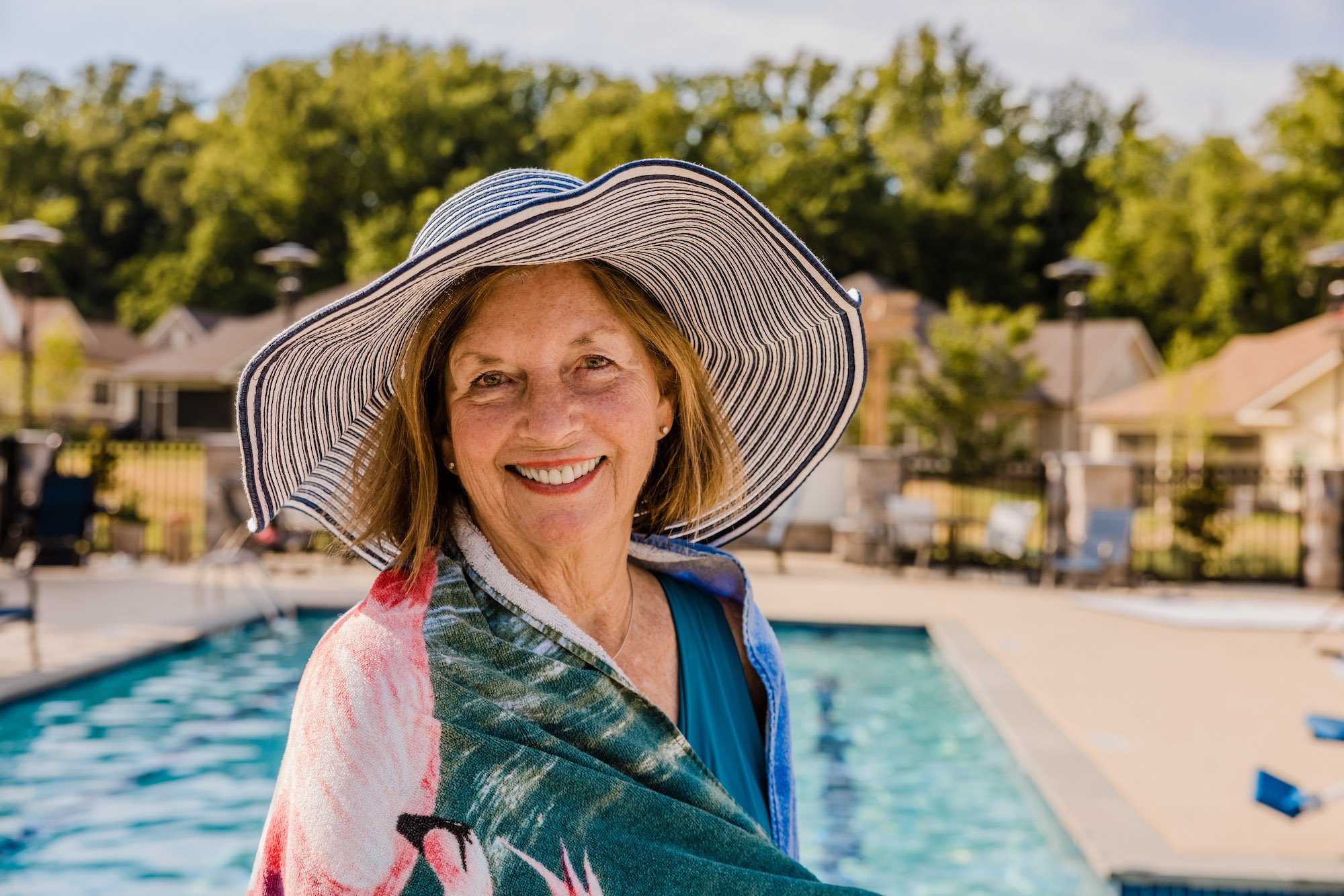 Woman standing next to a pool