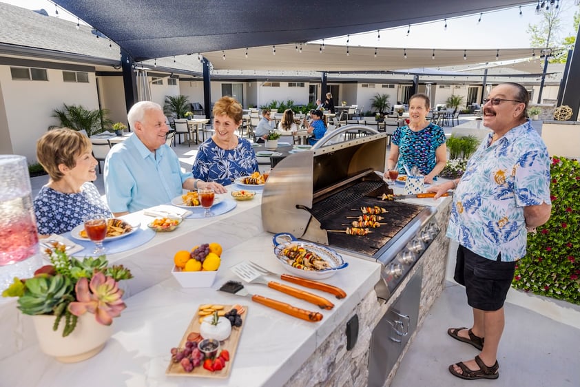 Residents enjoying a bbq at an oudoor grill