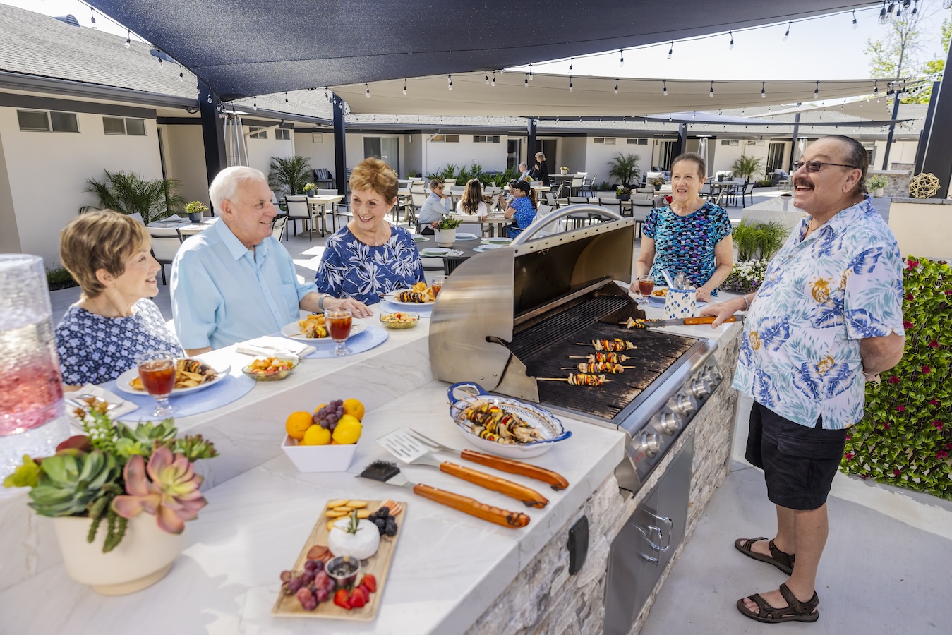 Residents enjoying a bbq at an oudoor grill