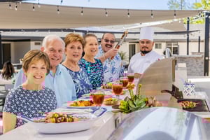 Group of seniors at an outdoor bbq with chef