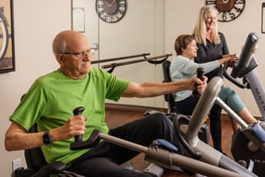 Man and woman on working out on exercise bikes