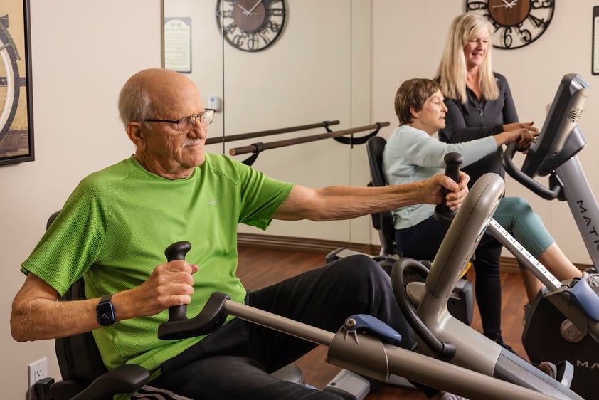 Man and woman on working out on exercise bikes