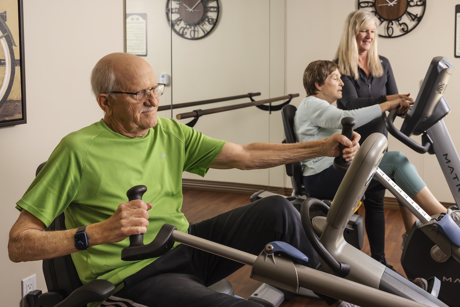 Man and woman on working out on exercise bikes