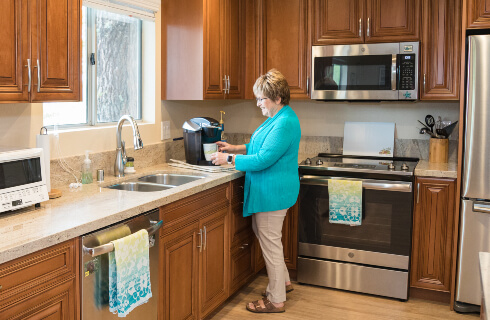 senior living resident enjoying a kitchen